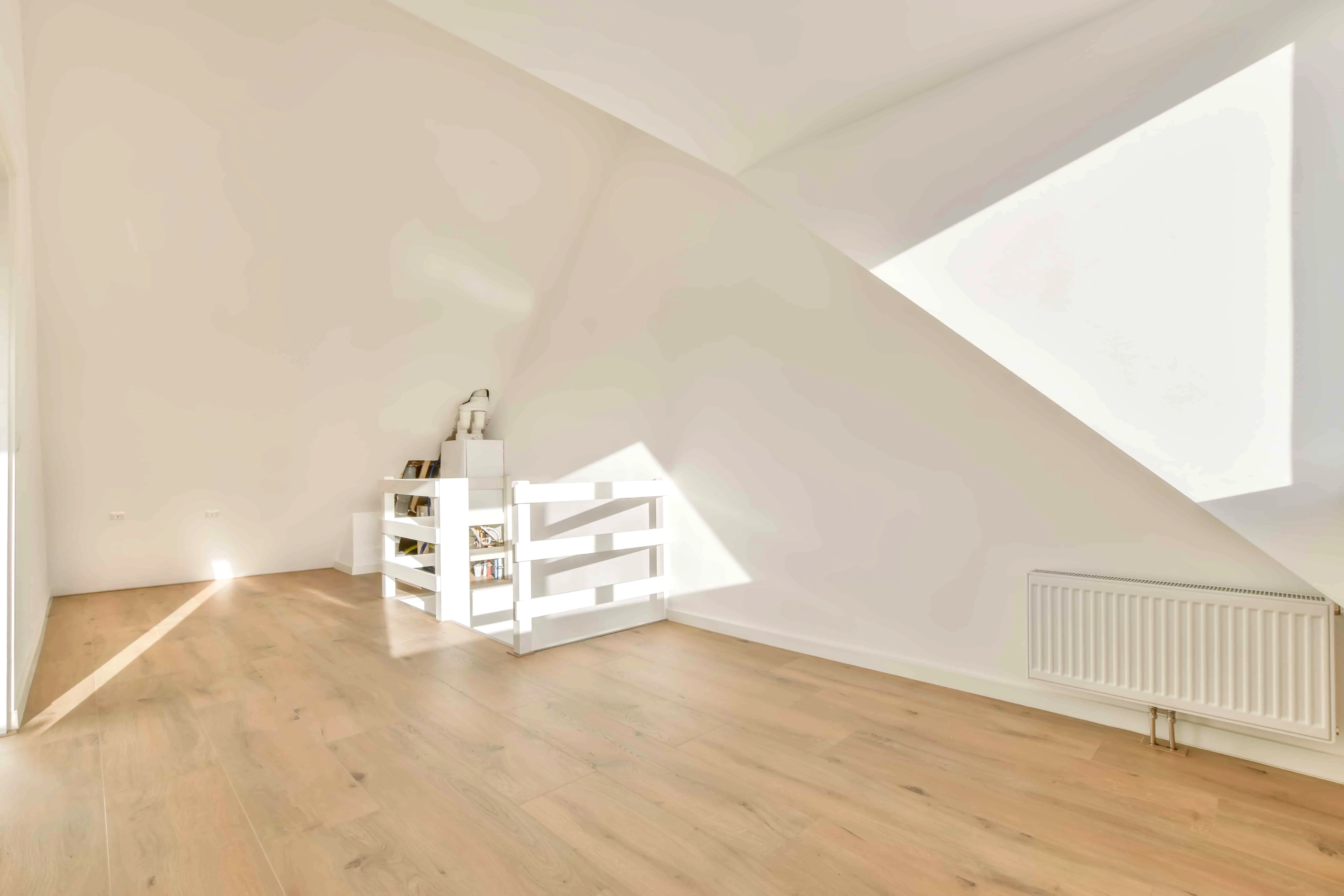 Spacious empty attic room with stairs